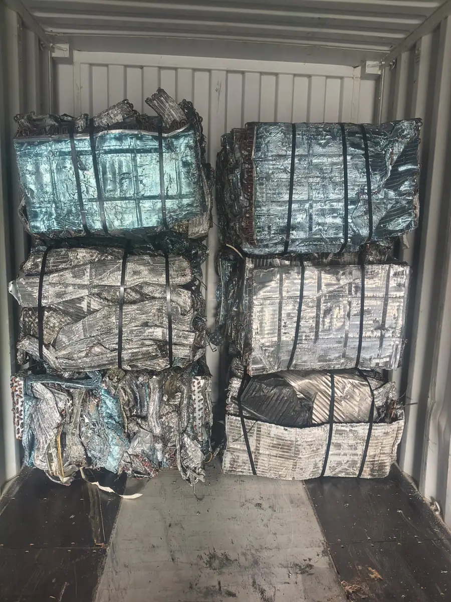 Bales of aluminium packed two wide and three high inside a shipping container