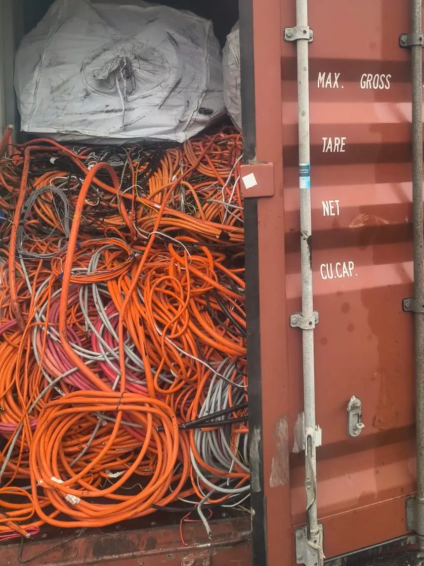 Container door open on orange cable with a bulka bag on top