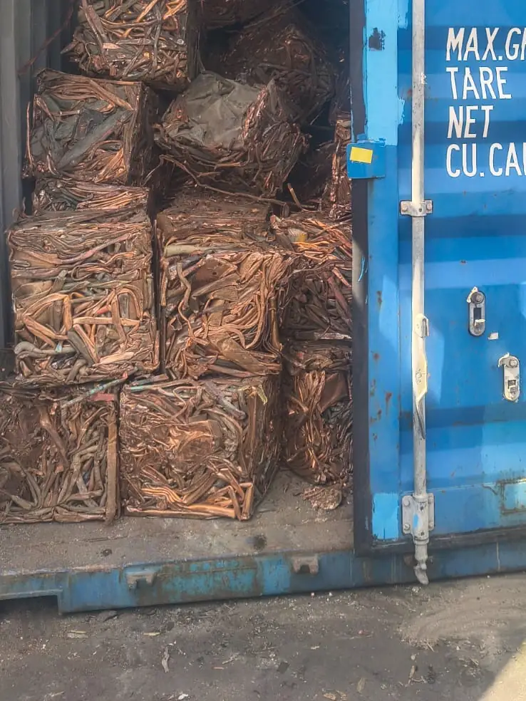 Shipping container at the Ingleburn yard, door open on stacked bales of copper
