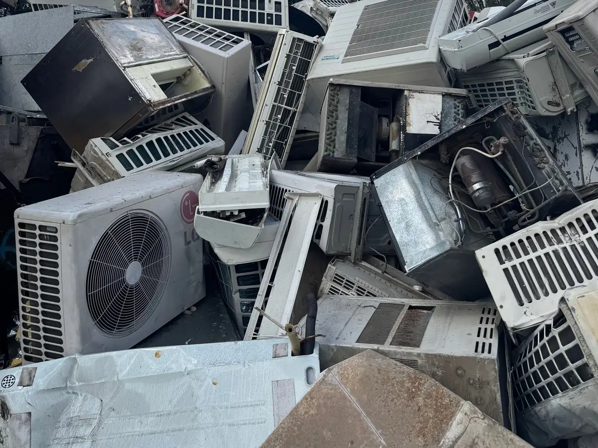 Split-system and window air conditioning units stacked at the Ingleburn yard