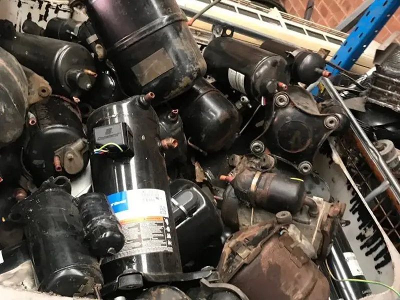 Fridge and air conditioner compressors in a stillage at the Ingleburn yard