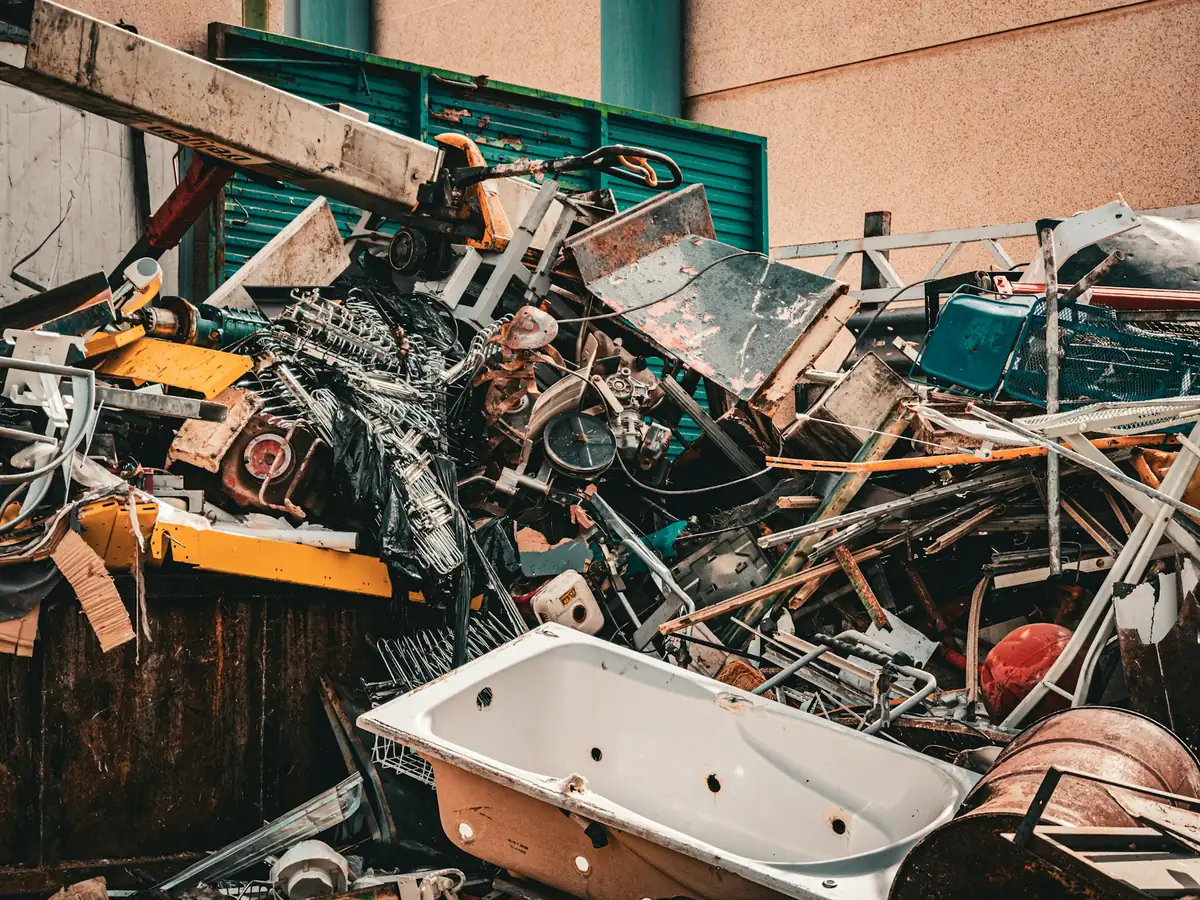 Pile of light gauge steel scrap with an old bathtub and appliances